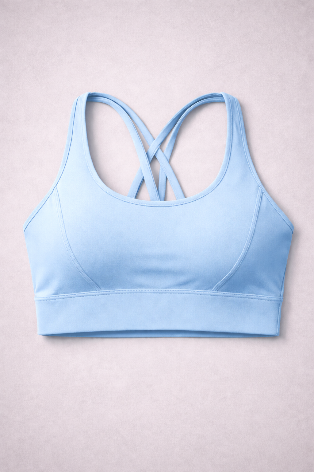 Brassière de sport AURA Icde Blue GLIIMA présentée à plat, avec fines bretelles croisées dans le dos.